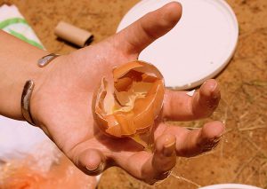 Broken egg in hand