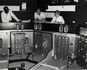 Dr. Calhoun (right) and his colleagues overlook the mouse enclosure.