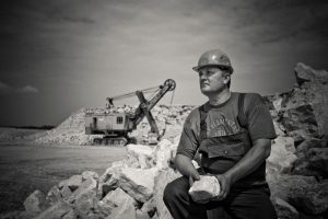 Man working hard at quarry.